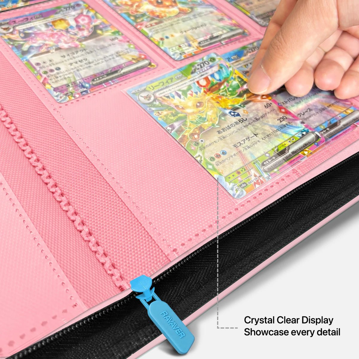 Hand sliding a holographic Leafeon Pokemon card into a clear pocket of a pink Mew card binder with a sky-blue zipper pull