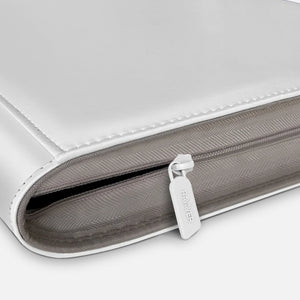 Close-up of premium white zipper on luxury Pokemon toploader binder with leather edge stitching