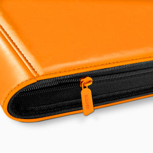 Close-up of the orange zipper pull and full-perimeter zip on an orange Charizard toploader binder