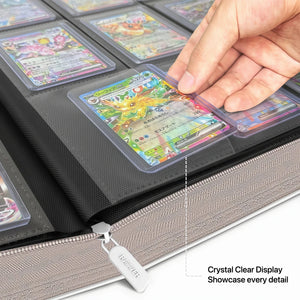 Hand placing a toploadered Pokemon card into a crystal-clear pocket on an open white toploader binder