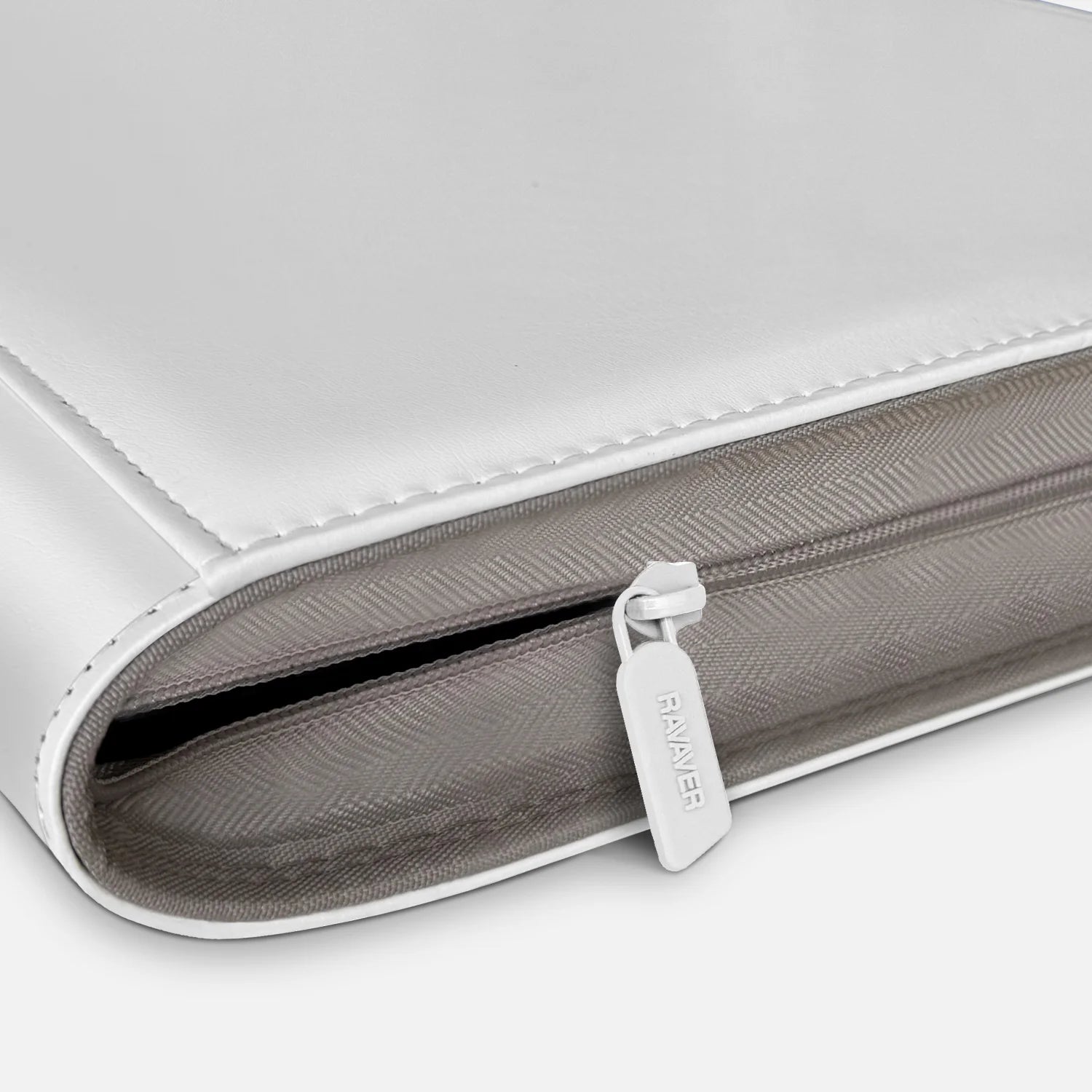 Close-up of premium white zipper on luxury Pokemon toploader binder with leather edge stitching