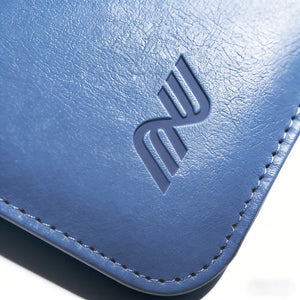 Close-up of the embossed logo and stitching on a blue leather Pokemon toploader binder corner