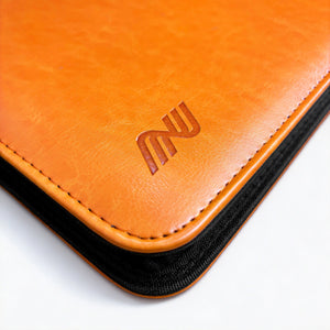 Close-up of the embossed logo pressed into the orange leather corner of a Charizard toploader binder