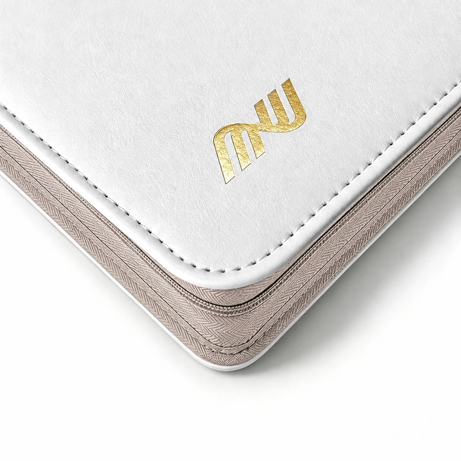 Close-up of the gold logo and stitching on a white leather Pokemon toploader binder corner