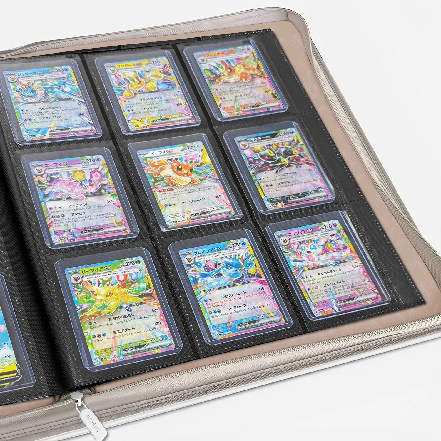 Open white Pokemon toploader binder showing 9-pocket pages filled with holographic cards in toploaders