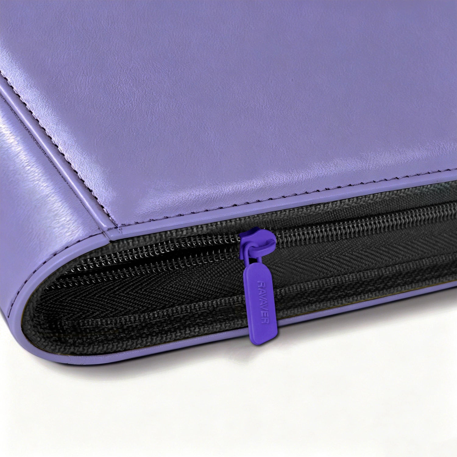 Close-up of purple zipper pull on Pokemon toploader binder with leather edge stitching