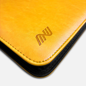 Close-up of embossed Pikachu and edge stitching on yellow leather toploader binder corner