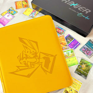Yellow Pokemon toploader binder displayed alongside holographic Pikachu cards and premium gift box