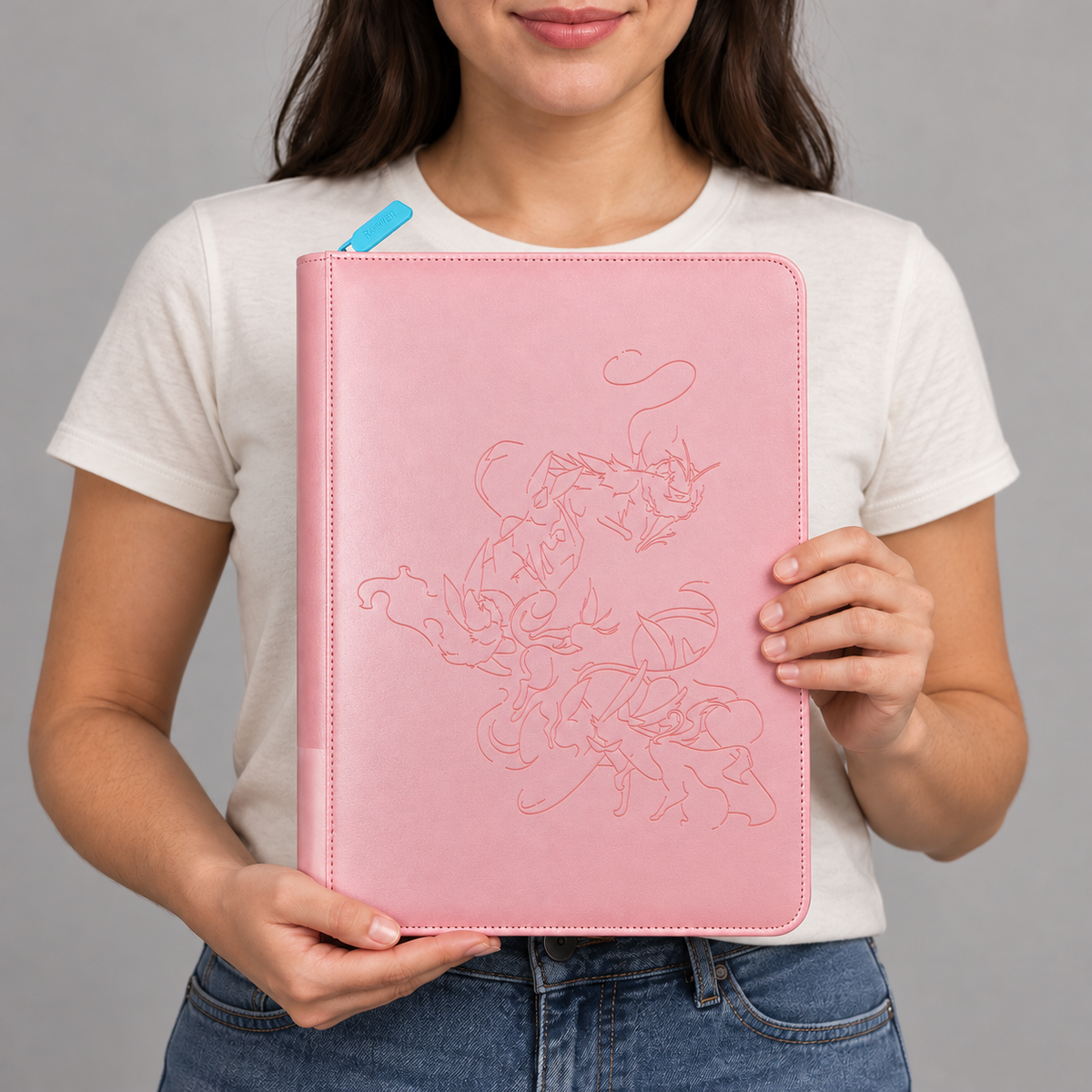 Collector holding a pink Eevee Family card binder with a line-art cover, sized for 360 cards