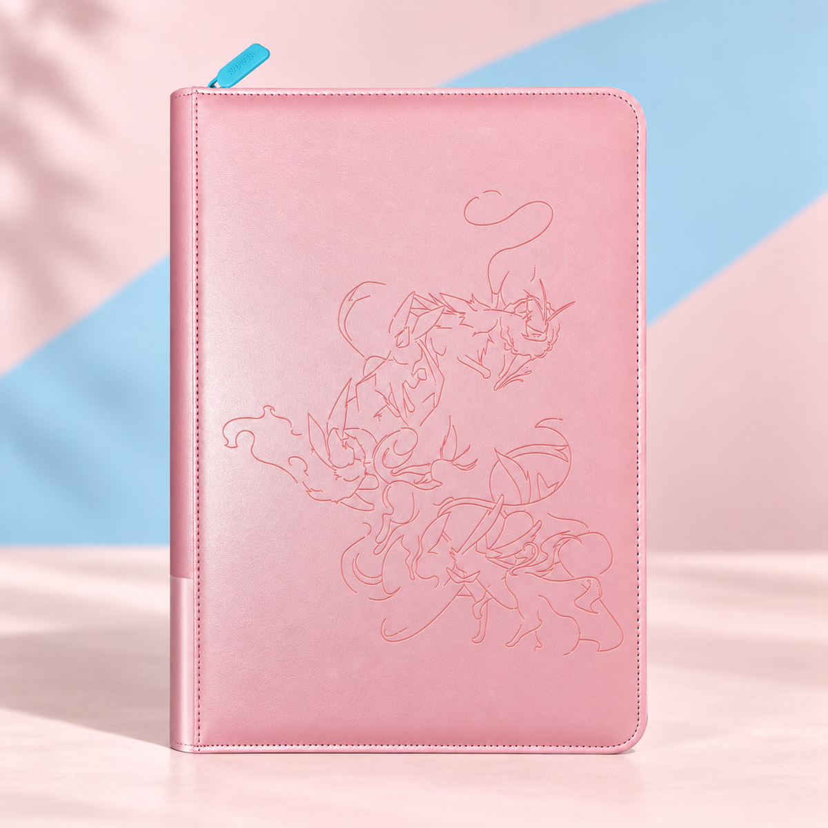 Pink Eevee Family card binder with debossed Eevee evolution line art on a pink and blue backdrop