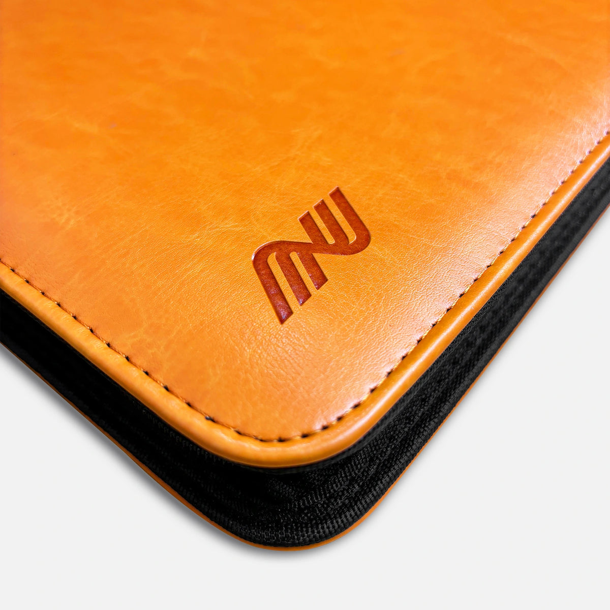 Close-up of the embossed logo, edge stitching and orange zipper tape on an orange leather card binder