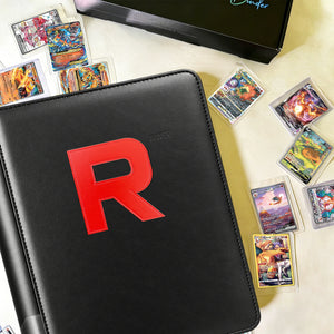 Black toploader binder displayed with Pokemon cards and a gift box